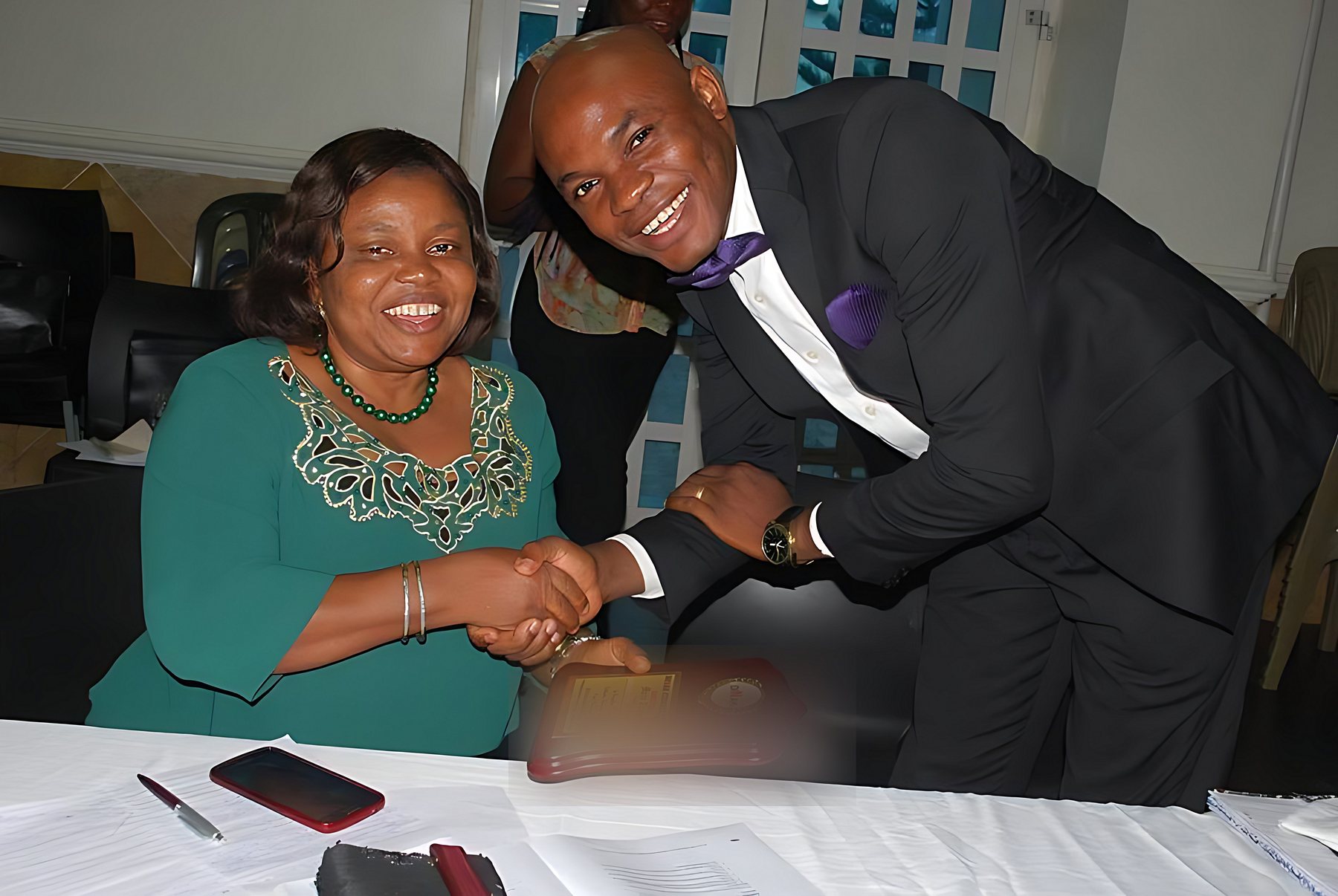 A participant presenting Chuba Nkala with a plaque
